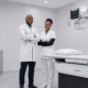 Healthcare professionals standing beside DRGEM X-ray machine in a modern medical imaging facility